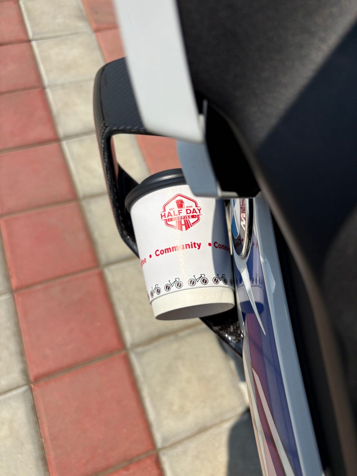 Coffee cup resting on a motorcycle