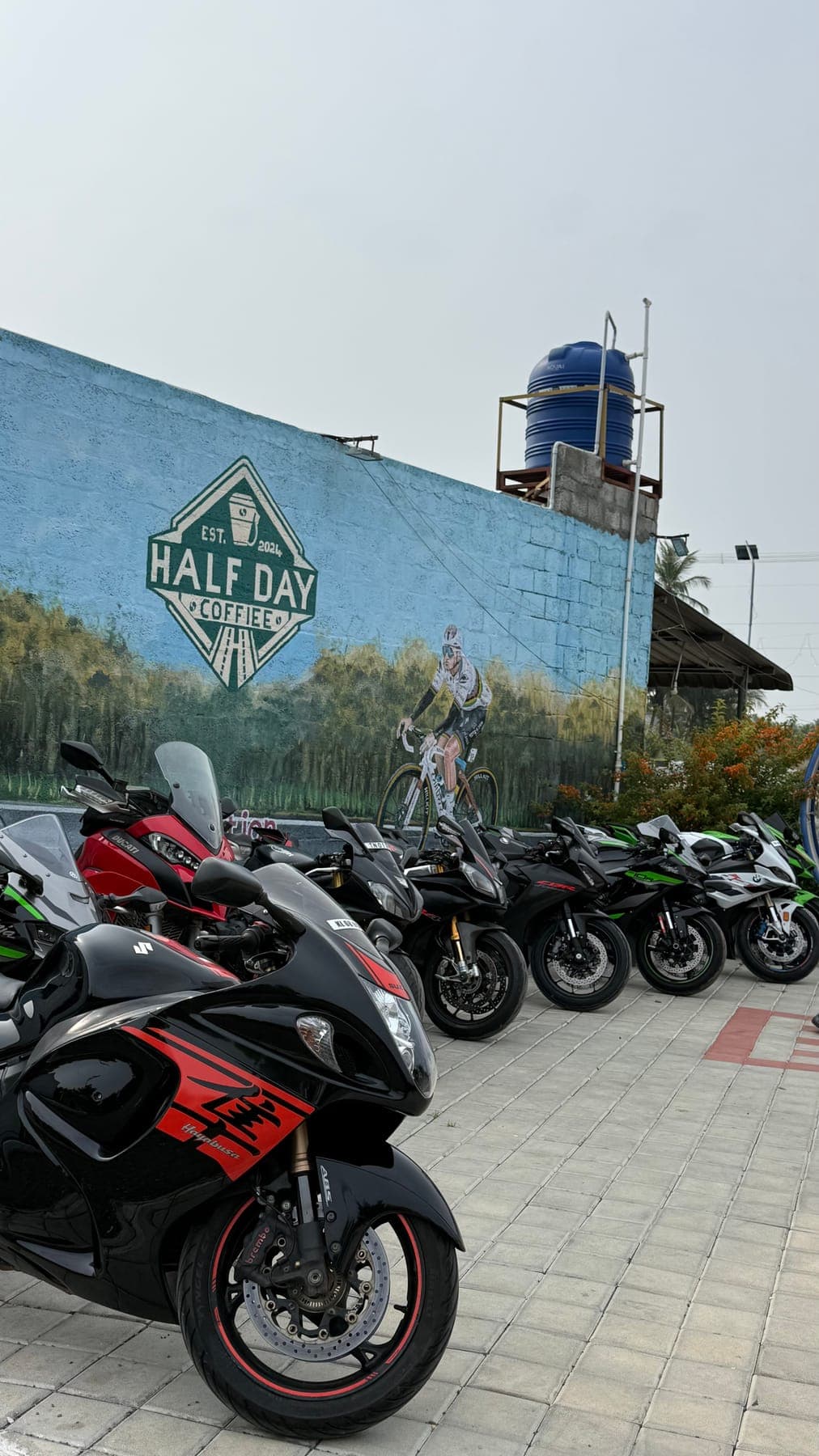 Motorcycles by the blue building