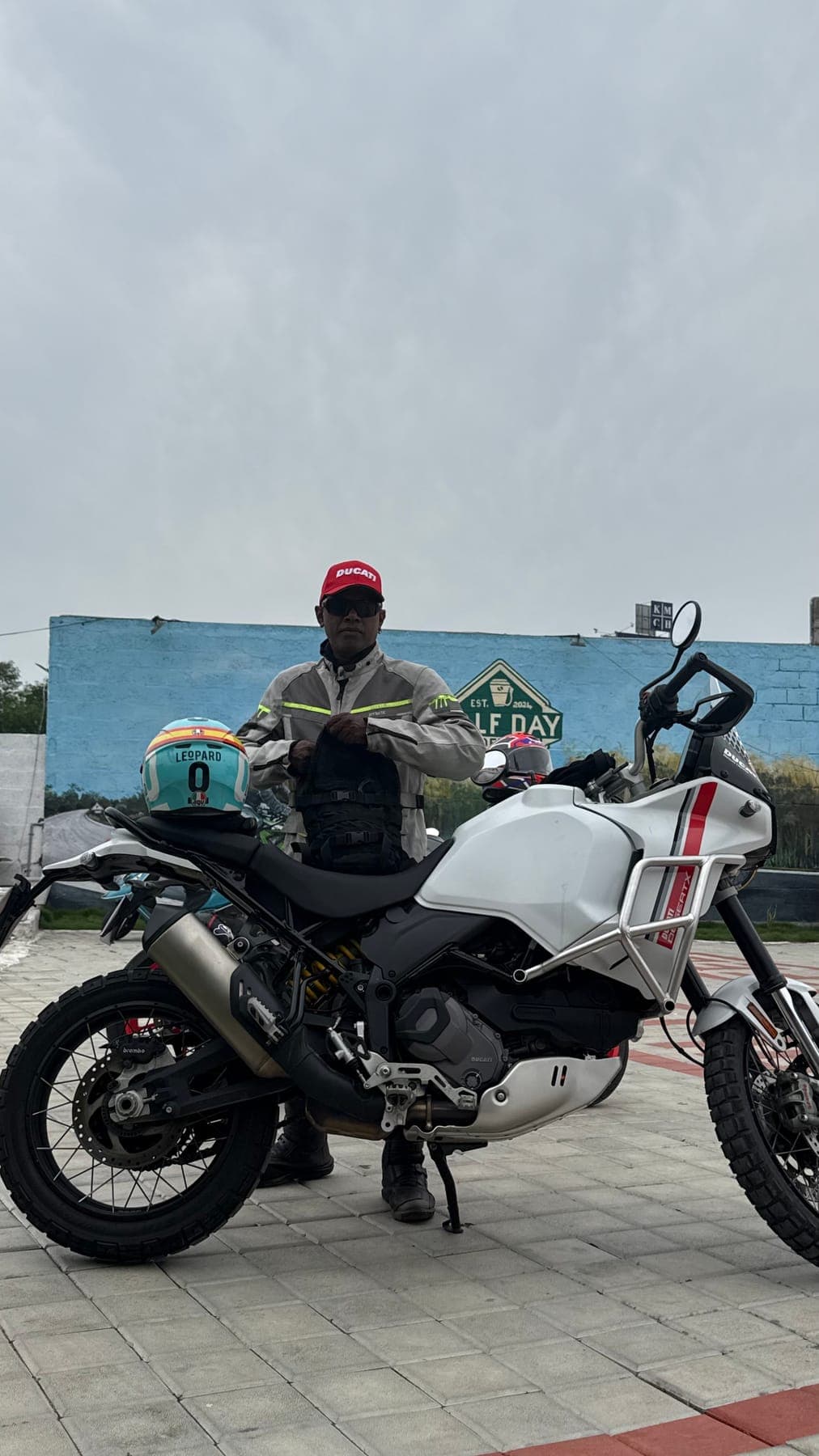 Motorcyclist beside their bike