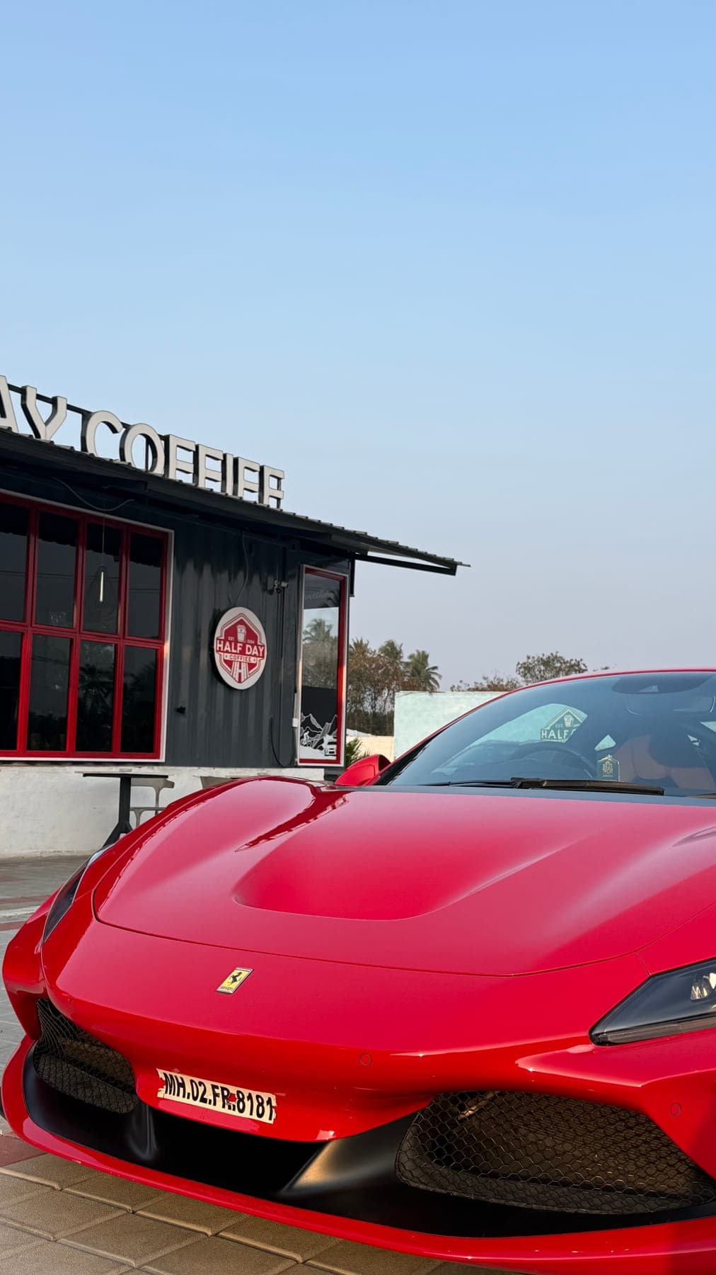 Red Ferrari at the cafe entrance