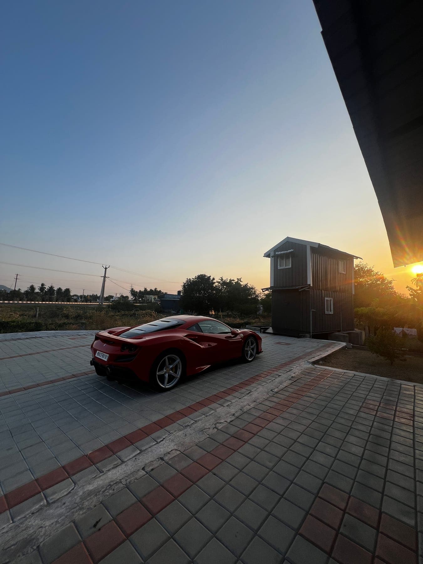 Red Ferrari at sunset on the highway