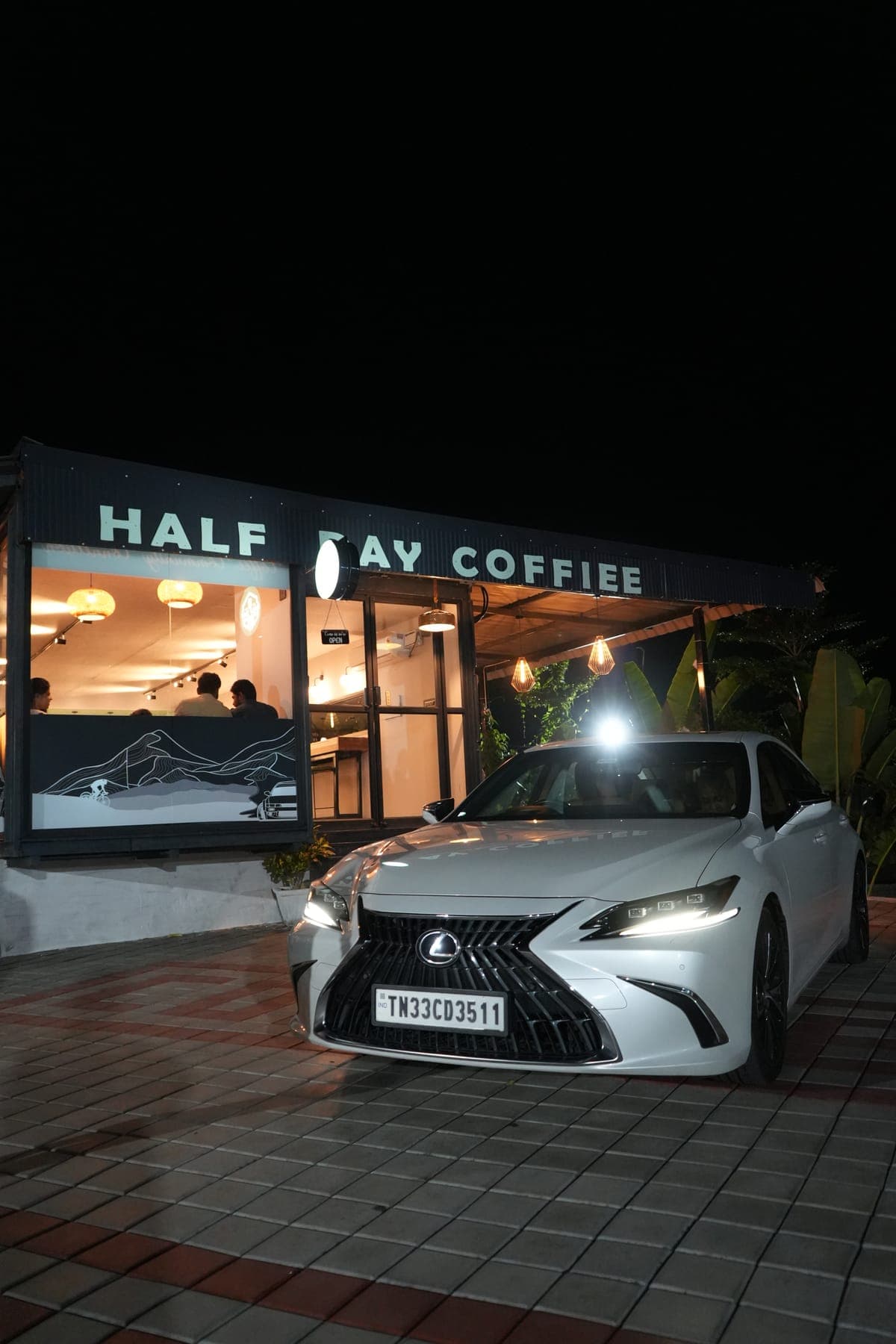 White car at the cafe at dusk
